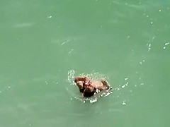 Nudist brunette woman sunbathing