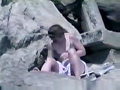 Fingering pussy at beach