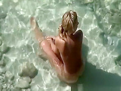 Blonde nude plays with dick in water