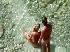 Blonde nude plays with dick in water
