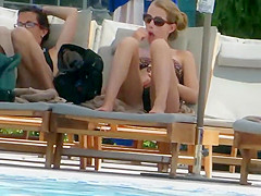 Teen rubs herself with lotion by the pool