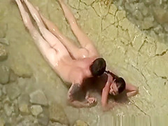 Nudist couple enjoying the fresh water