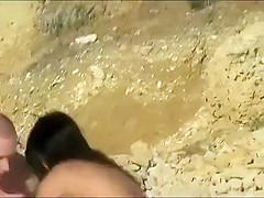 Naked couple making out on a beach