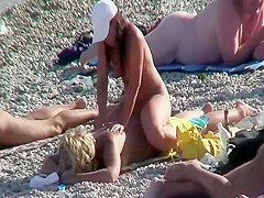 Daughter massages mother on a beach