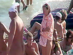Daughter massages mother on a beach