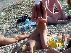 Daughter massages mother on a beach
