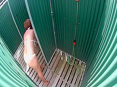Mature lady caught in a beach shower