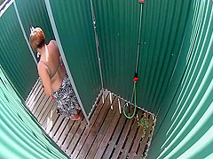 Mature lady caught in a beach shower
