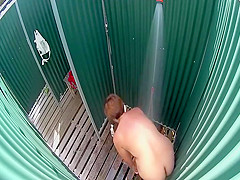 Mature lady caught in a beach shower