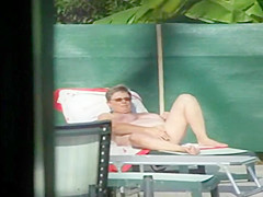 Milf thinks she's all alone at a pool