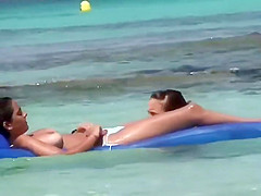 Topless sisters spied on an air mattress