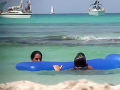 Topless sisters spied on an air mattress