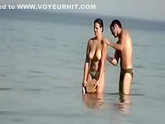Dude playing around with a topless girl