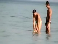 Dude playing around with a topless girl