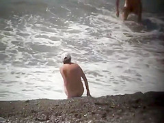 Naturists enjoying the wavy sea