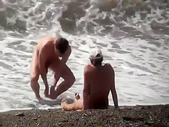 Naturists enjoying the wavy sea