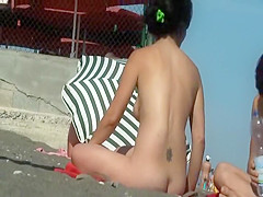 Hairy butt crack of a naked beach girl