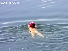 Naked girl at a lake side beach