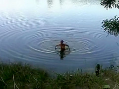 Naked girl at a lake side beach