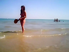 Naked girl plays in the shallow water