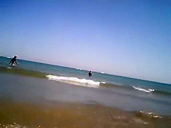 Naked girl plays in the shallow water