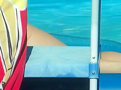 Peeping her naked floating at her pool