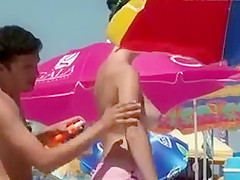 Gigantic natural boobs spied on a beach