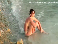 Sunburned woman is naked on a beach