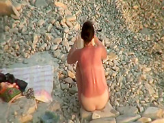 Sunburned woman is naked on a beach