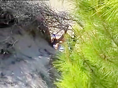 Aroused girl rubbing her pussy on a beach