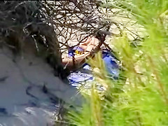 Aroused girl rubbing her pussy on a beach