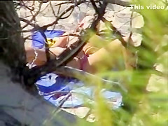 Aroused girl rubbing her pussy on a beach