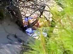 Aroused girl rubbing her pussy on a beach