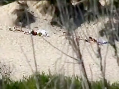 Aroused girl rubbing her pussy on a beach