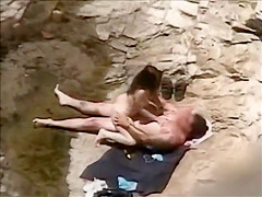 She rides his dick on a beach