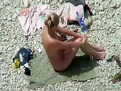 Nude milf on a beach and her hairy pussy