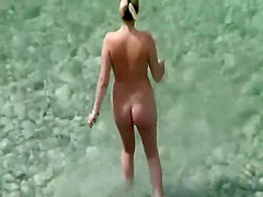 Nude milf on a beach and her hairy pussy