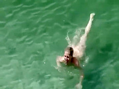 Nude milf on a beach and her hairy pussy