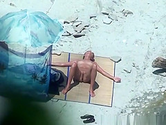 Shaved pussy nudist sunbathes