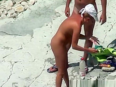 Nudist couple refreshing in the water