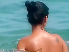 Topless woman in see