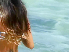 Sexy and tattooed asian beach babe