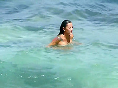 Sexy and tattooed asian beach babe