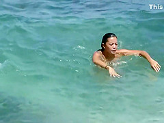 Sexy and tattooed asian beach babe