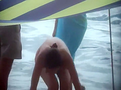 Sexy woman getting a beach massage