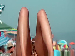 Nudist woman reading book in the beach