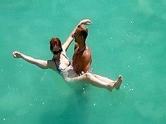 He teaches her how to swim