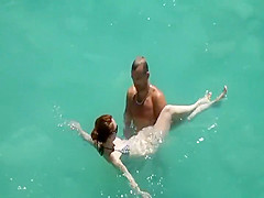 He teaches her how to swim