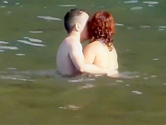 Stones on a naked beach woman