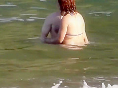 Stones on a naked beach woman